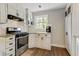 Well-equipped kitchen featuring stainless steel appliances, ample counter space, and white cabinets with sleek hardware at 604 Continental Dr, Lawrenceville, GA 30044