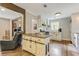 Open kitchen featuring an island, stainless steel appliances, custom cabinets, and beautiful floors at 604 Continental Dr, Lawrenceville, GA 30044