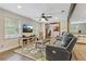 Open floorplan living room with hardwood floors, neutral paint, and comfortable leather seating at 604 Continental Dr, Lawrenceville, GA 30044