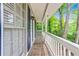 Front porch with wooden flooring, white railings, and natural sunlight at 604 Continental Dr, Lawrenceville, GA 30044