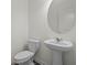 Stylish pedestal sink and toilet in a modern, well-lit powder room at 119 Champions Blvd., Dallas, GA 30157