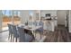 Bright dining room with modern table and chairs, open to the kitchen with a large sliding glass door at 119 Champions Blvd., Dallas, GA 30157