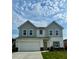 Charming two-story home with a large garage and a well-maintained lawn at 119 Champions Blvd., Dallas, GA 30157