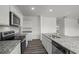Modern kitchen featuring granite countertops, stainless steel appliances, and white cabinets, ideal for cooking at 119 Champions Blvd., Dallas, GA 30157