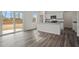 Contemporary kitchen with a sliding glass door to the backyard, modern appliances, and sleek flooring at 119 Champions Blvd., Dallas, GA 30157
