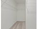 Spacious walk-in closet featuring white walls, neutral carpet, and ample storage with built-in shelving at 119 Champions Blvd., Dallas, GA 30157