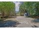 Spacious backyard with ample parking, featuring a shed and playset, surrounded by mature trees at 148 Hurt Road Sw, Smyrna, GA 30082