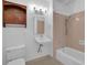 Bathroom with tile surround in the shower, white tile floor, and wood cabinet at 148 Hurt Road Sw, Smyrna, GA 30082
