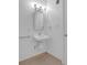 Bright white bathroom featuring tiled floors, a pedestal sink, and accessible design at 148 Hurt Road Sw, Smyrna, GA 30082