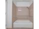 Bathroom features a white bathtub, shower, grab bars and tile surround at 148 Hurt Road Sw, Smyrna, GA 30082