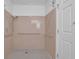 Bathroom features a tiled shower, grab bars, and a white door at 148 Hurt Road Sw, Smyrna, GA 30082