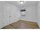 Bedroom features wood-look flooring, a window with blinds, and a closet at 148 Hurt Road Sw, Smyrna, GA 30082