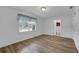 Bedroom with wood-look floors, bright window, and doorway to an attached bathroom at 148 Hurt Road Sw, Smyrna, GA 30082