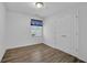 Bright bedroom features wood-look flooring, window with blinds, and closet at 148 Hurt Road Sw, Smyrna, GA 30082