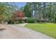 Quaint brick home featuring a driveway and lush green lawn at 148 Hurt Road Sw, Smyrna, GA 30082