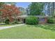 Charming brick home with a well-maintained lawn and mature trees at 148 Hurt Road Sw, Smyrna, GA 30082