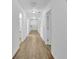 Long hallway with wood-look floors and white walls, leading to various rooms at 148 Hurt Road Sw, Smyrna, GA 30082