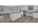 Open concept kitchen featuring wood-look floors, a center island, and stainless appliances at 148 Hurt Road Sw, Smyrna, GA 30082
