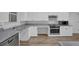 Kitchen featuring stainless steel appliances, plenty of cabinets, and wood-look flooring at 148 Hurt Road Sw, Smyrna, GA 30082