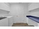 Laundry room with white washer and dryer, built-in cabinets and blue countertop at 148 Hurt Road Sw, Smyrna, GA 30082