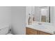 Bathroom featuring a white sink, matching white countertop, and staircase view at 1608 Indian Way, Cumming, GA 30040