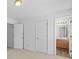 Spacious bedroom with neutral carpet, white walls, two doors, and a view into an ensuite bathroom at 1608 Indian Way, Cumming, GA 30040