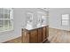 Kitchen island with hardwood floors, stainless steel appliances, and a bay window for natural light at 1608 Indian Way, Cumming, GA 30040