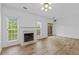 Bright living room with hardwood floors, a fireplace, and natural light at 1608 Indian Way, Cumming, GA 30040