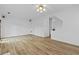 Open-concept living room with hardwood floors, recessed lighting, and neutral paint scheme, perfect for entertaining at 1608 Indian Way, Cumming, GA 30040