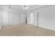 Spacious main bedroom with three doors, neutral walls and carpet, and ceiling fan at 1608 Indian Way, Cumming, GA 30040
