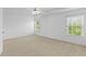 Bright main bedroom with natural light, ceiling fan, and plush carpeting at 1608 Indian Way, Cumming, GA 30040