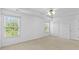 Bright main bedroom with neutral walls, two windows, and plush carpeting at 1608 Indian Way, Cumming, GA 30040