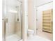 Bathroom featuring a glass enclosed shower, toilet and shelving at 3621 Vinings Slope Se # 3510, Atlanta, GA 30339