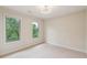 Bright bedroom featuring carpet floors and large windows with green views at 3621 Vinings Slope Se # 3510, Atlanta, GA 30339