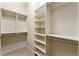 Spacious walk-in closet with custom shelving and ample storage space with carpeting at 3621 Vinings Slope Se # 3510, Atlanta, GA 30339