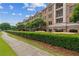 Upscale mixed-use building featuring brick facade, balconies, lush green landscaping, and street-level commercial spaces at 3621 Vinings Slope Se # 3510, Atlanta, GA 30339