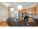 Updated kitchen features stainless steel appliances, granite countertops, and pendant lighting at 3621 Vinings Slope Se # 3510, Atlanta, GA 30339