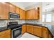 Well-lit kitchen features granite countertops, stainless steel appliances, and light wood cabinetry at 3621 Vinings Slope Se # 3510, Atlanta, GA 30339