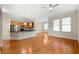 Open-concept living room and kitchen featuring hardwood floors, stainless appliances, and great natural light at 3621 Vinings Slope Se # 3510, Atlanta, GA 30339