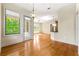 Bright living room area showcasing hardwood floors, balcony access, and a view into the kitchen at 3621 Vinings Slope Se # 3510, Atlanta, GA 30339