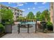Outdoor pool area with greenery and lounge chairs at 3621 Vinings Slope Se # 3510, Atlanta, GA 30339