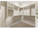 Spacious walk-in closet with custom shelving and hanging rods at 3621 Vinings Slope Se # 3510, Atlanta, GA 30339