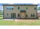 Back exterior of home with a small patio and grassy backyard at 5285 Winflow Way, Suwanee, GA 30024