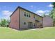 Home exterior with a brick section and a view of the well-manicured lawn at 5285 Winflow Way, Suwanee, GA 30024