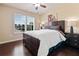 Cozy bedroom with a queen bed, natural light, and hardwood floors at 5285 Winflow Way, Suwanee, GA 30024