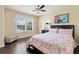 Bright bedroom with hardwood floors, natural light, and a queen-sized bed at 5285 Winflow Way, Suwanee, GA 30024