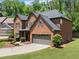 Charming brick home showcases a well-kept lawn and attached two-car garage at 5285 Winflow Way, Suwanee, GA 30024