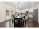 Lovely eat-in kitchen boasts white cabinets and stainless steel appliances at 5285 Winflow Way, Suwanee, GA 30024