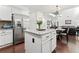 Bright, open kitchen with island, stainless steel appliances, and hardwood floors at 5285 Winflow Way, Suwanee, GA 30024