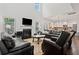 Open living room with a fireplace and kitchen area in the background at 5285 Winflow Way, Suwanee, GA 30024